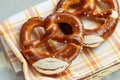 Two traditional soft Octoberfest pretzels in bread basket, close-up Royalty Free Stock Photo