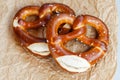 Two traditional soft Octoberfest pretzels on brown paper Royalty Free Stock Photo