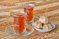 Two traditional turkish glass cups of black tea with sweet profiteroles on wooden table. Morning breakfast for two Royalty Free Stock Photo