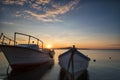 Two traditional wooden fishing boats in the sea. Fishing boats tied up in harbor at the end of the day. Sunset near the Black Sea Royalty Free Stock Photo