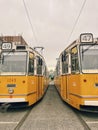 Two traditional yellow trams in Budapest Hungary