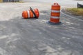 Two traffic barrels, one overturned, metaphor for safe driving, construction zone, accidents, creative copy space Royalty Free Stock Photo