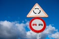 two traffic signs, one for roundabout warning and the other one for no pass signs Royalty Free Stock Photo