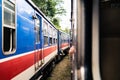 Two trains in Sri Lanka waiting at station. Railway travel and rail tourism. Old colorful blue and red heritage coach.