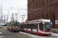 Two Tram Going Towards Each Other On The Street Under Snow, Winter, Red Brick Old Building, Road