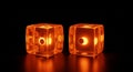 Two Translucent Orange Dice Glowing with Internal Light on a Reflective Black Surface gambling Royalty Free Stock Photo