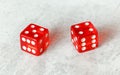 Two translucent red craps dices on white board showing Centerfield Nine Nina number 5 and 4