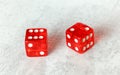 Two translucent red craps dices on white board showing Easy Eight number 6 and 2