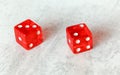 Two translucent red craps dices on white board showing Fever Five Little Phoebe number 3 and 2