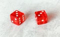 Two translucent red craps dices on white board showing Hard Six double number three