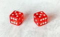 Two translucent red craps dices on white board showing Hard Ten number 5 twice Royalty Free Stock Photo