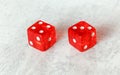 Two translucent red craps dices on white board showing Natural or Seven Out number 4 and 3