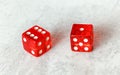 Two translucent red craps dices on white board showing Natural or Seven Out number 6 and 1