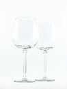 Two transparent elegant crystal glasses for cocktails and wine on a white background Royalty Free Stock Photo