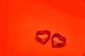 Two transparent glass hearts on a bright red background. Royalty Free Stock Photo