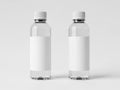 Two transparent plastic bottles with white caps on a white background Royalty Free Stock Photo