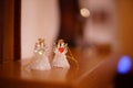 Two transparent statuettes of small angels on the mantelpiece