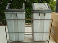 Two Trash Cans in Front of the Garden Royalty Free Stock Photo