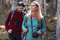 Two travel hikers with backpack walking while looking the landscape in the forest