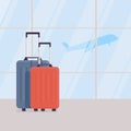 Two travel suitcases against background of large windows in waiting area of airport terminal, view of plane taking off Royalty Free Stock Photo