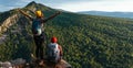 Two travelers on the background of mountains, panorama. Travelers at sunset in the mountains. Tourists with backpacks Royalty Free Stock Photo