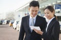 Two travelers looking at ticket in airport Royalty Free Stock Photo