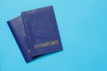 Two travelers passports on blue background. Travel concept