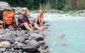 Two travelers refreshing on the mountain riverside