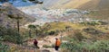 Two of trekker walk to village at Himalayas trail on the way to Everest base camp, Khumbu valley, Sagarmatha national park, Royalty Free Stock Photo