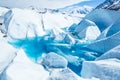 Two trekkers above a frozen glacier lake in Alaska`s Chugach Mountains Royalty Free Stock Photo