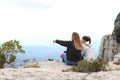 Two trekkers contemplating nature in a cliff