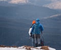 Two trekkers hikers with backpacks walking in the mountains. Carpathian mountain. Royalty Free Stock Photo