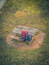 Two trekking mountain climbing hiking backpacks on a wooden bench aerial drone view