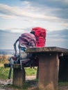 Two trekking mountain climbing hiking backpacks on a wooden bench