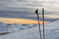 Two trekking sticks stuck in the snow. Sport concept