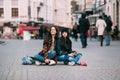 Two trendy and fashionable street girls skateboarders joking and smiling