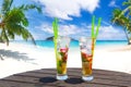 Two tropical cocktails on the beach table for the perfect summer vacation Royalty Free Stock Photo