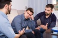 Two troubled men talking with friend Royalty Free Stock Photo