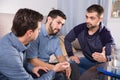 Two troubled men talking with friend Royalty Free Stock Photo