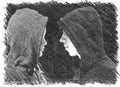 Two troubled teenage boys with black hoodie standing in front of each other in profile isolated on black background. Black and whi