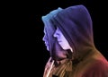 Two troubled teenage boys with black hoodie standing next to each other in profile isolated on black background. creative colorful Royalty Free Stock Photo