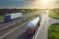 Two trucks on the highway at sunset in motion Royalty Free Stock Photo