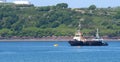 Two tugs stand sentinel to help protect the environment and vessels in the Cleddau estuary near to Pembroke Dock, Wales Royalty Free Stock Photo