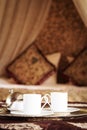 Two turkish coffee cups with oriental canopy bed at the background