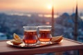 Two Turkish glasses in form of a tulip filled with hot black tea with view to the roofs of Istanbul, Turkey