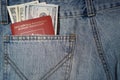 American dollars and foreign passport in the jeans pocket Royalty Free Stock Photo