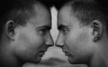 Two twin guys look each other in the eyes. close-up, black and white