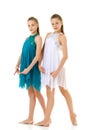 Two Twin Sisters Dancing Wearing White and Blue Sport Dresses Royalty Free Stock Photo