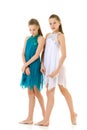 Two Twin Sisters Dancing Wearing White and Blue Sport Dresses Royalty Free Stock Photo