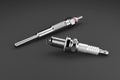 Two types of glow plug and spark plug on a black background. 3d rendering Royalty Free Stock Photo